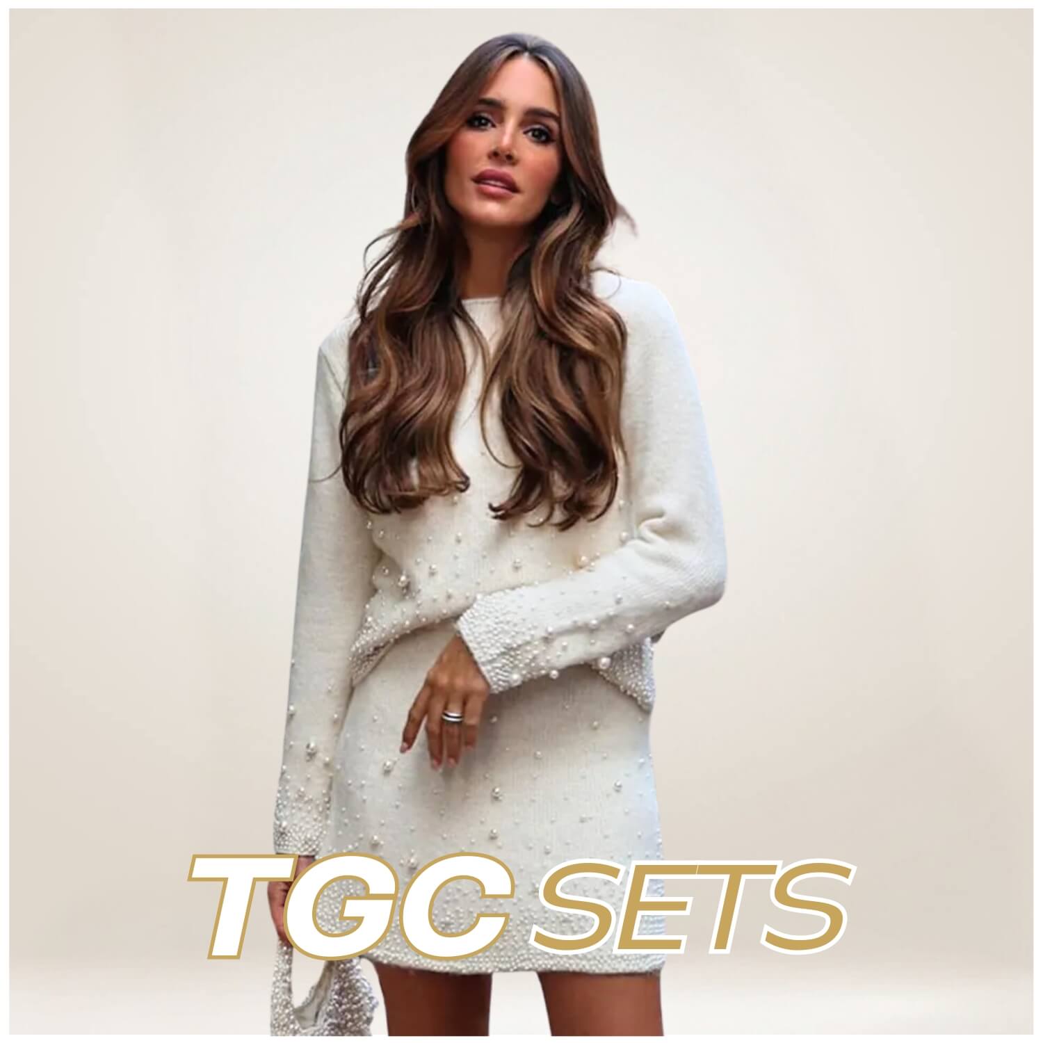 A woman with long, wavy brown hair wears a stylish white knit set with pearl embellishments. She poses confidently against a neutral background. The text "TGC SETS" is prominently displayed at the bottom of the image.