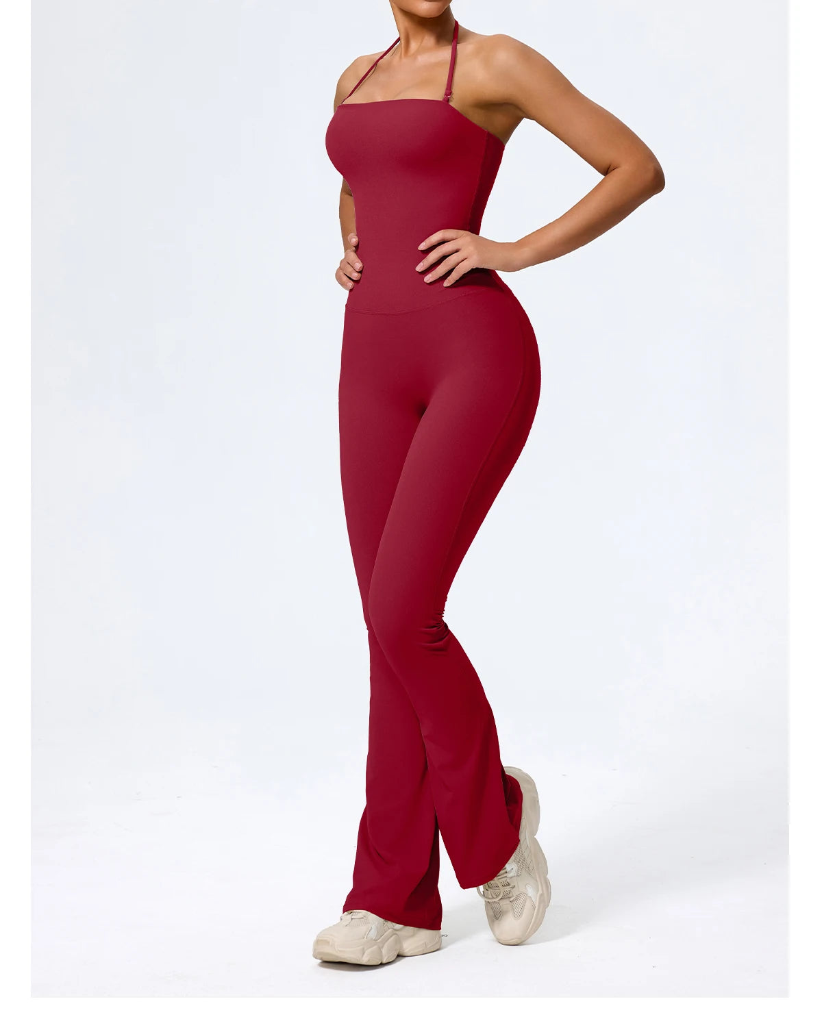 Red one piece jumpsuit, front view with hand on hip