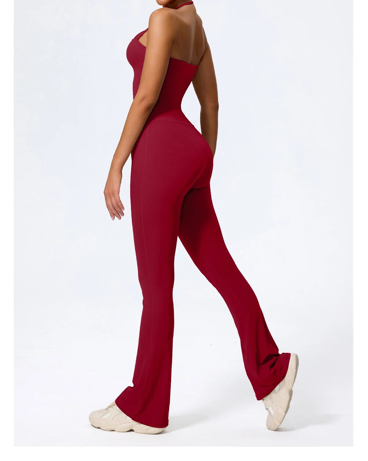 Red casual jumpsuit for women, side view mid-stride