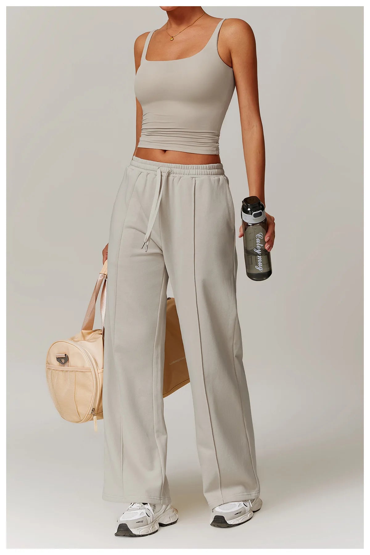 Khaki tank top and trousers, full length front view