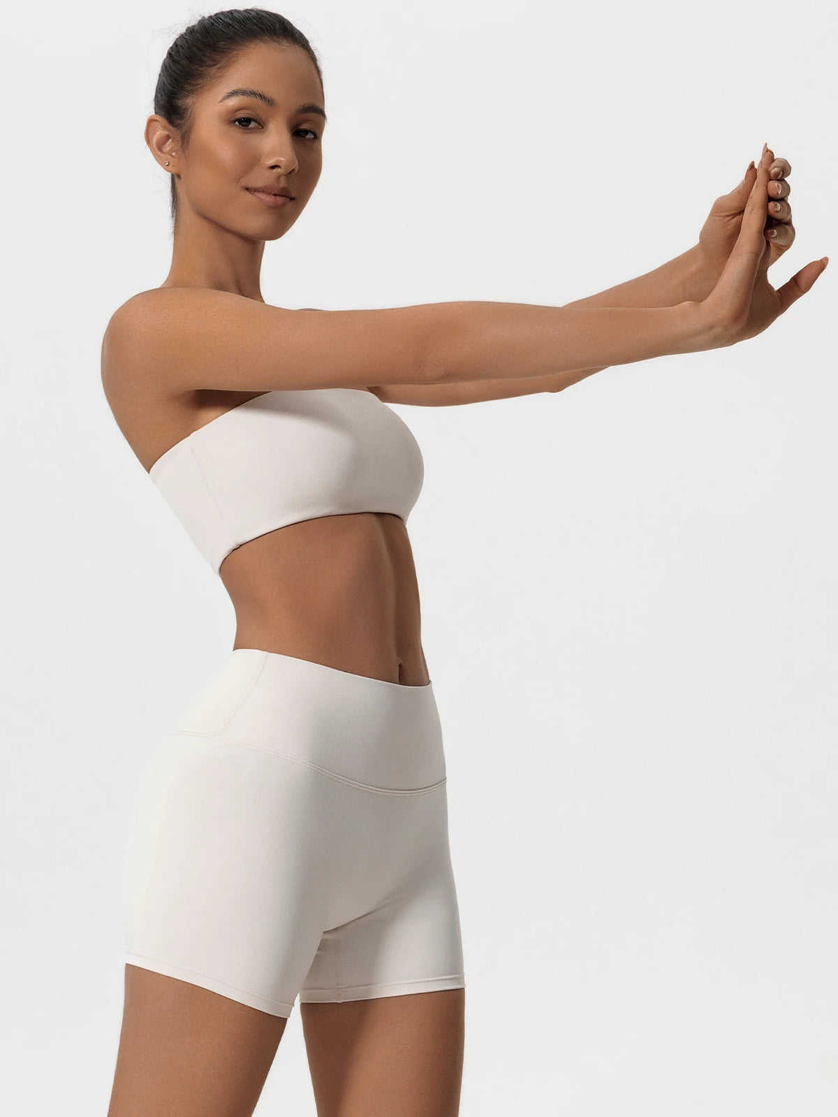 Ivory matching workout set, model stretching, side view