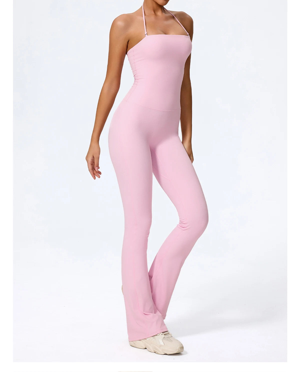 Halter jumpsuit in pink, three-quarter view with the halter strap tied at the neck