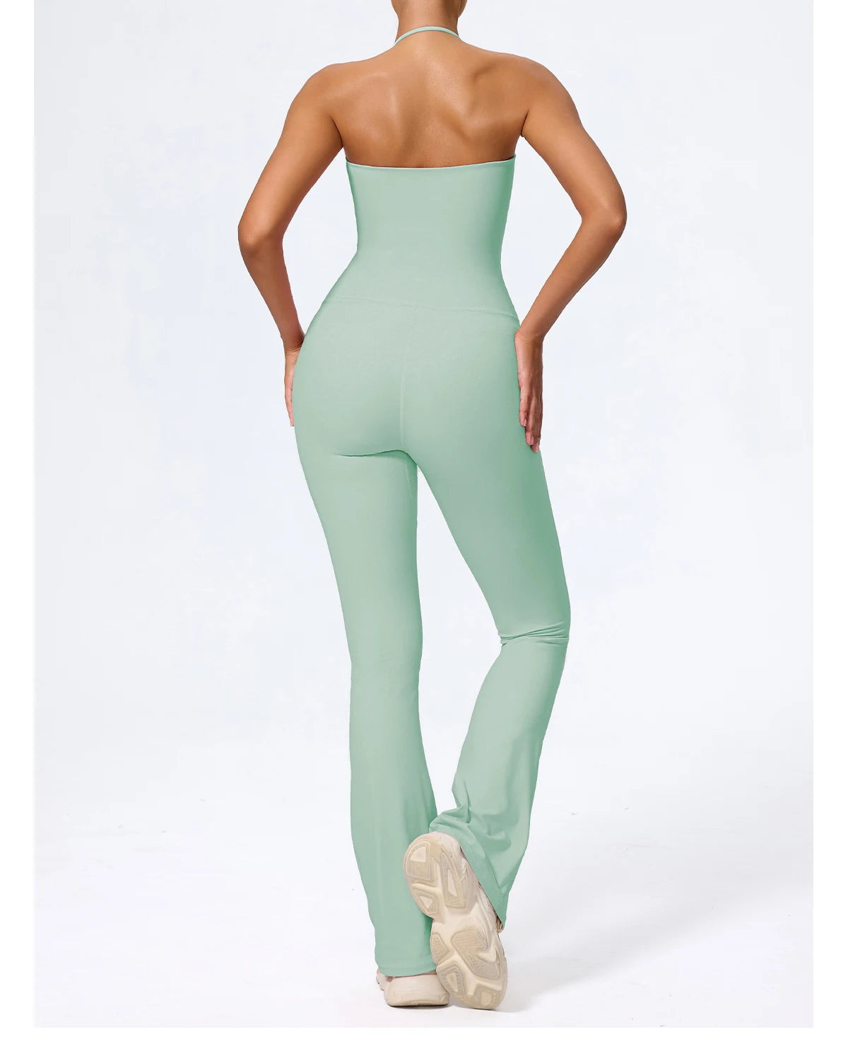 Sage green jumpsuit back view showing the open back and halter tie