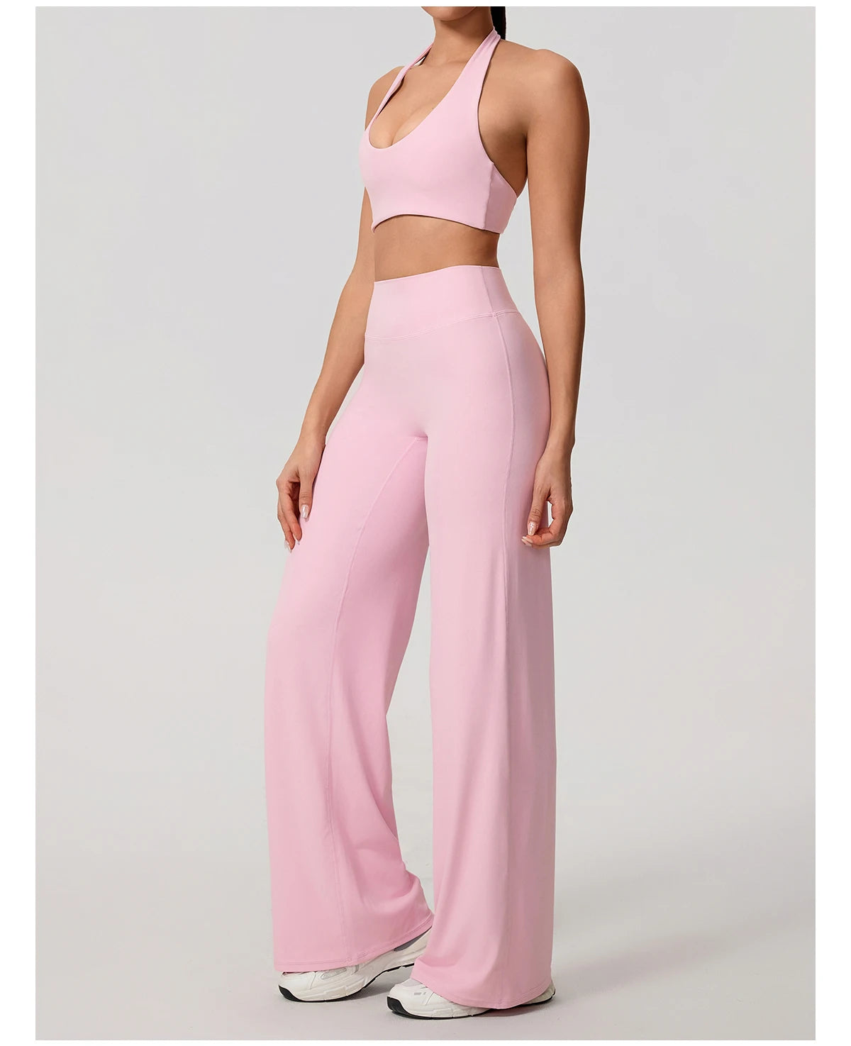 Pink workout sets in peach, halter bra and wide leg trousers front view