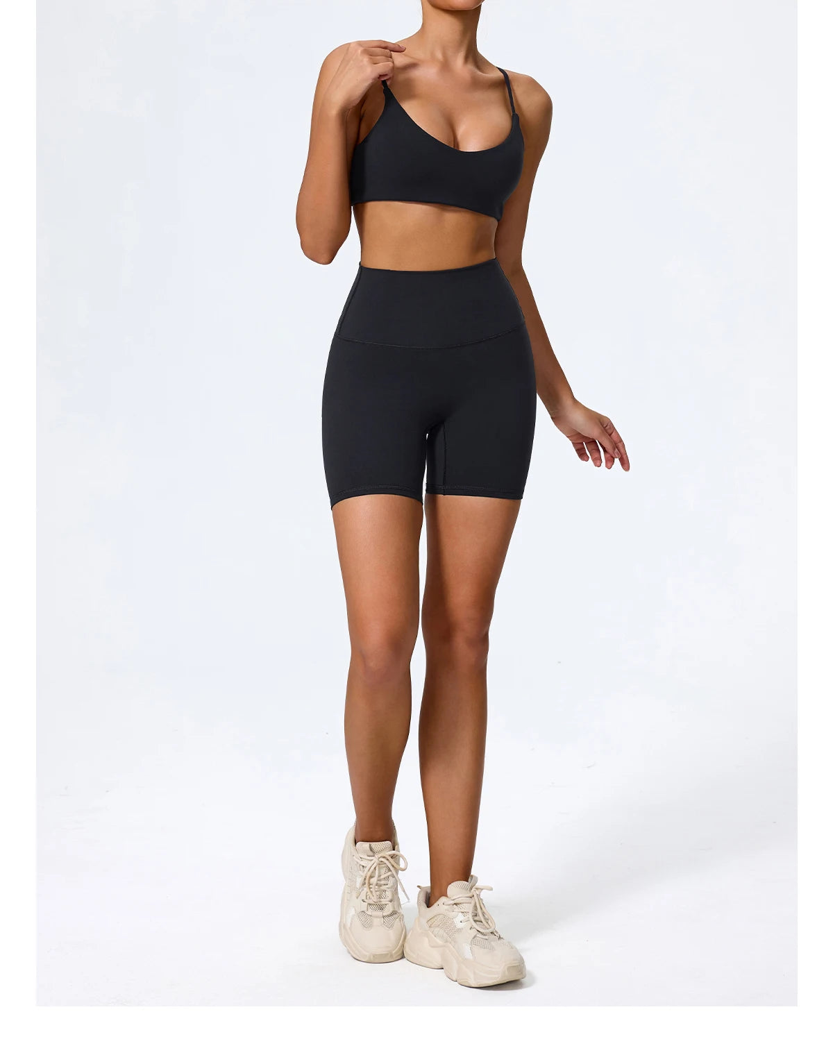 Black biker shorts and sports bra set, front view on model