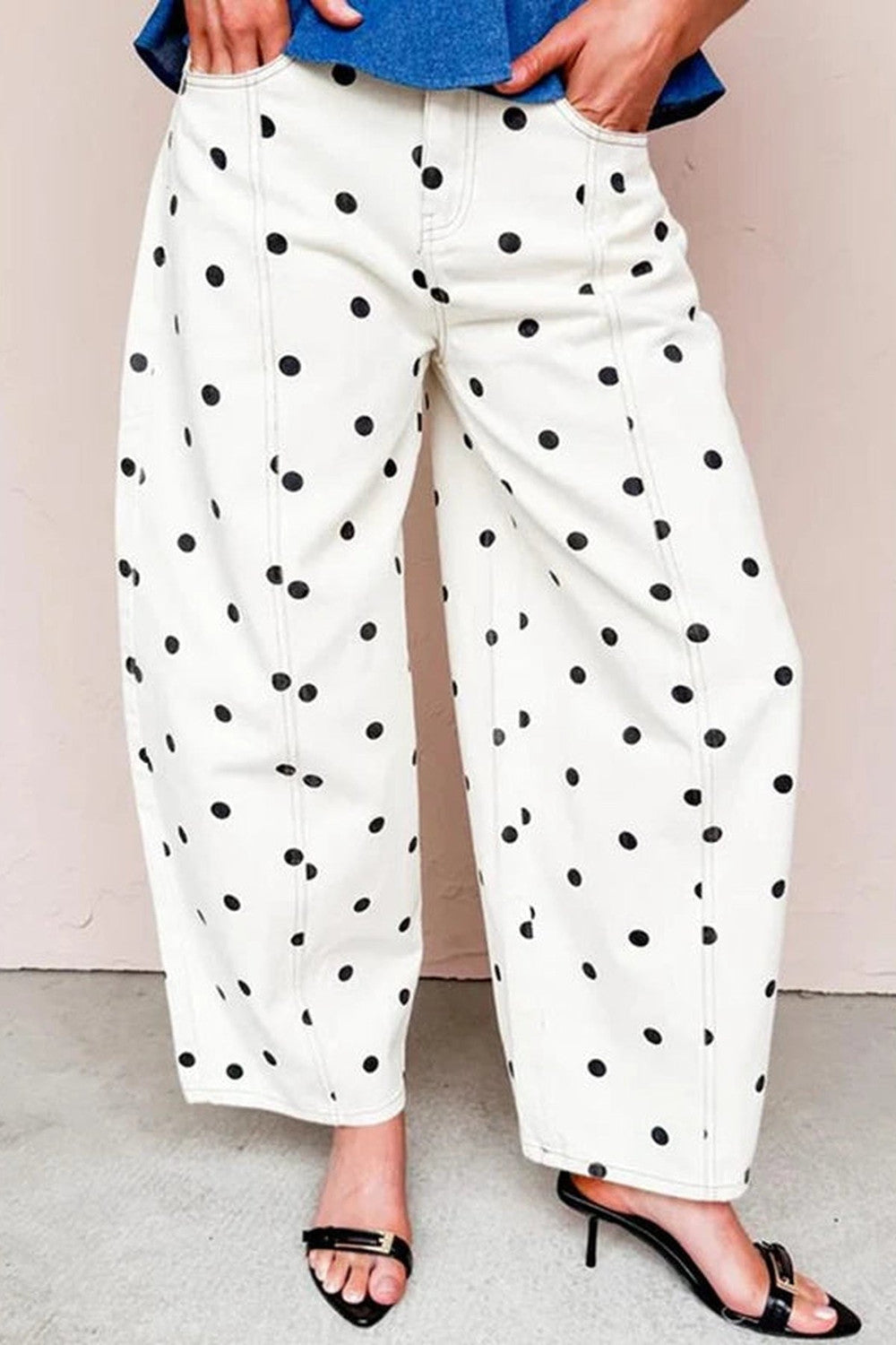White barrel jeans with black polka dot print worn with black strappy heels