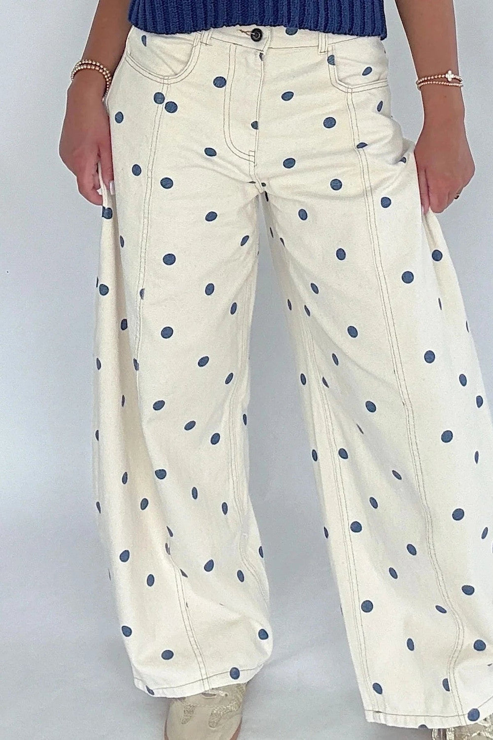 Ivory barrel jeans with navy polka dot print and a mid rise waistband