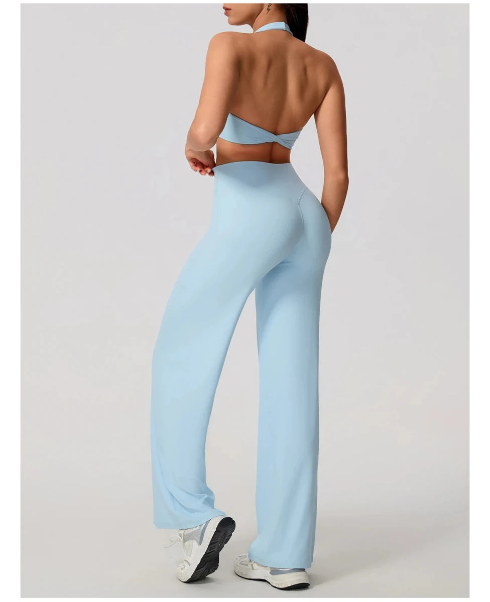 Cloud blue pilates outfit with open back halter bra and wide leg trousers, back view