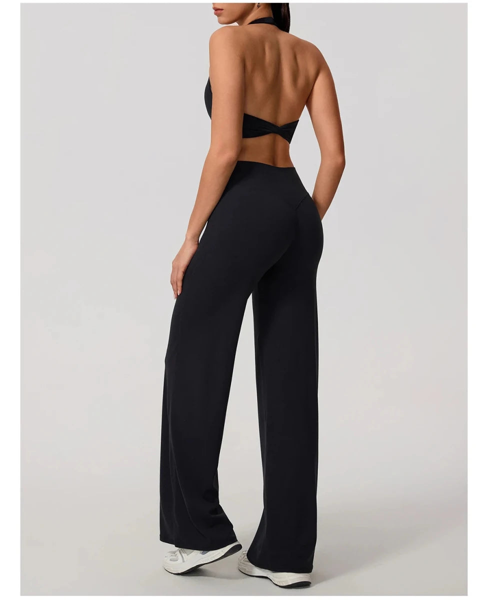 Black pilates outfit with open back halter bra and wide leg trousers, back view