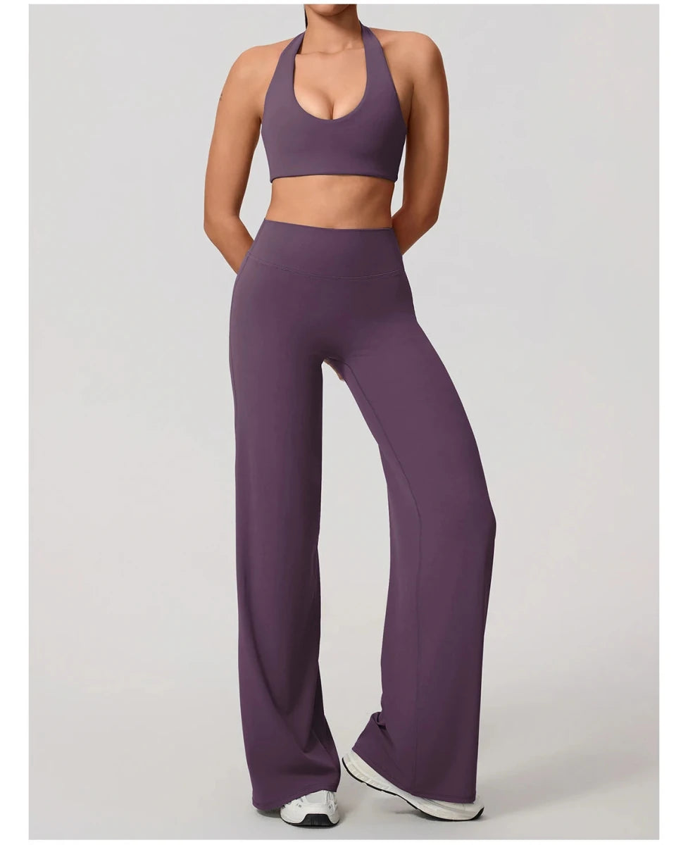 Smoke purple pilates outfit with open back halter bra and wide leg trousers, front