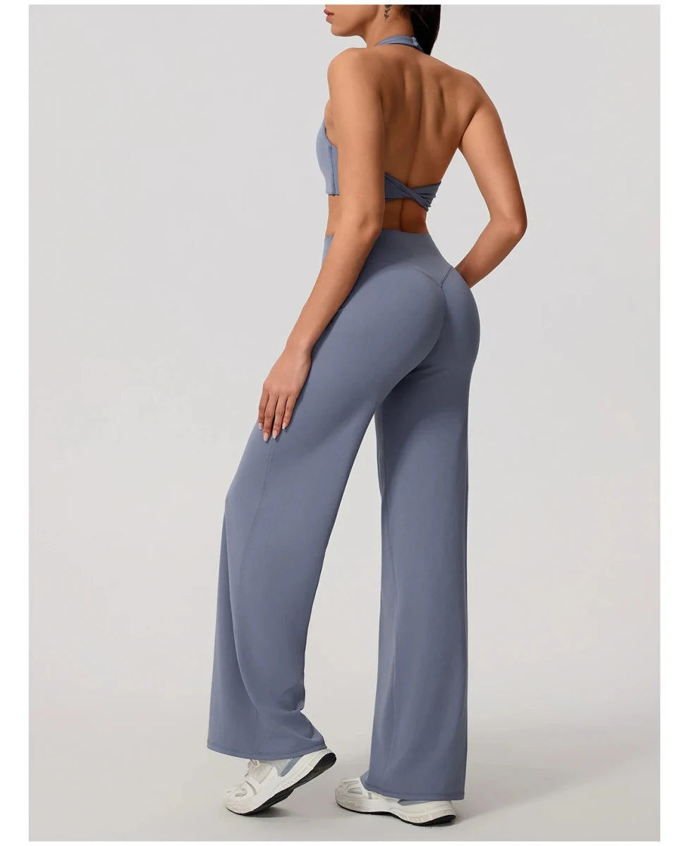 Granite blue pilates outfit with open back halter bra and wide leg trousers, back view, halter tie