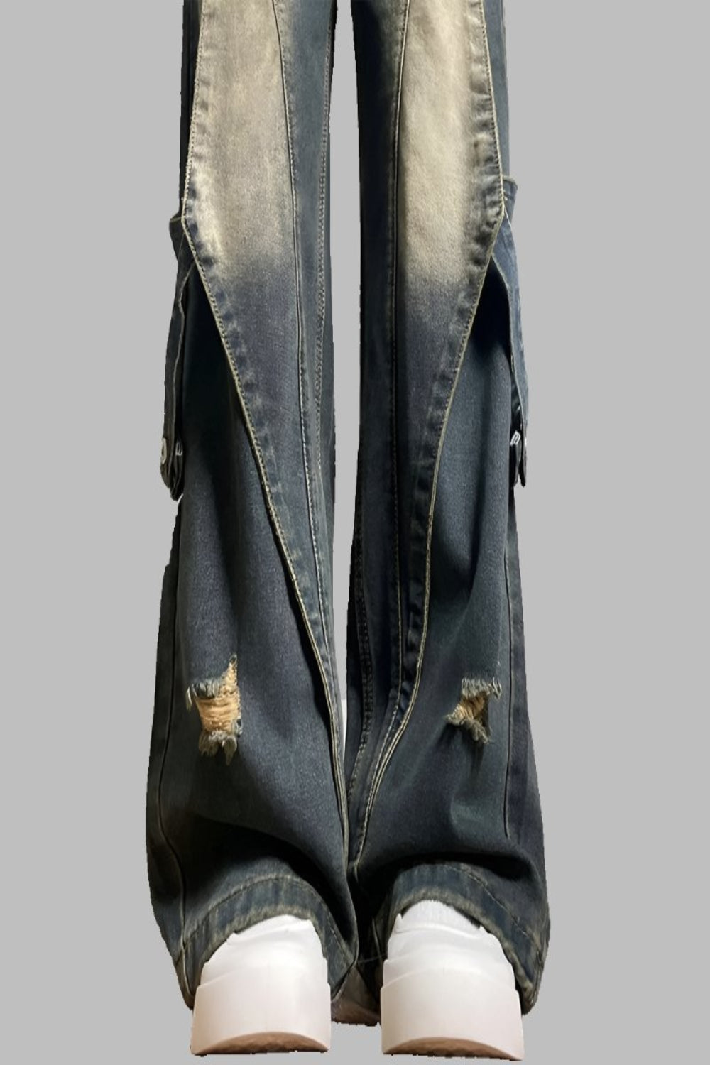 Two tone acid wash jeans, close up of bleached panels and knee rips