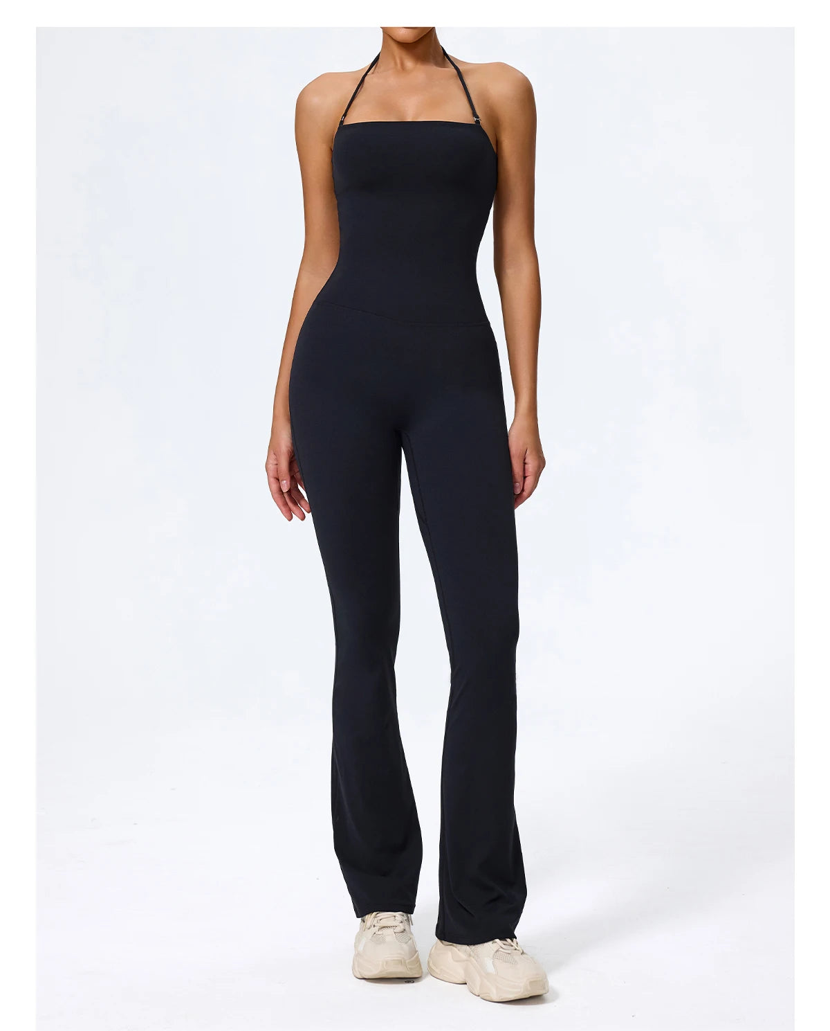 Black jumpsuit front view on model with white trainers