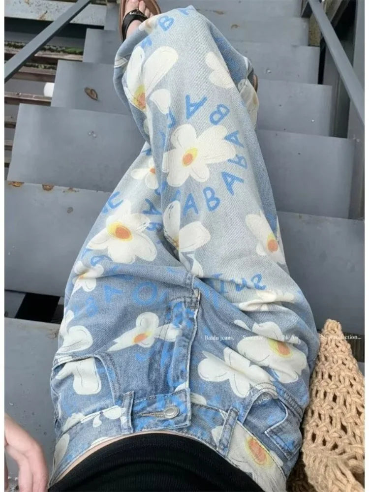 Close up of white daisy print and blue lettering on light wash denim