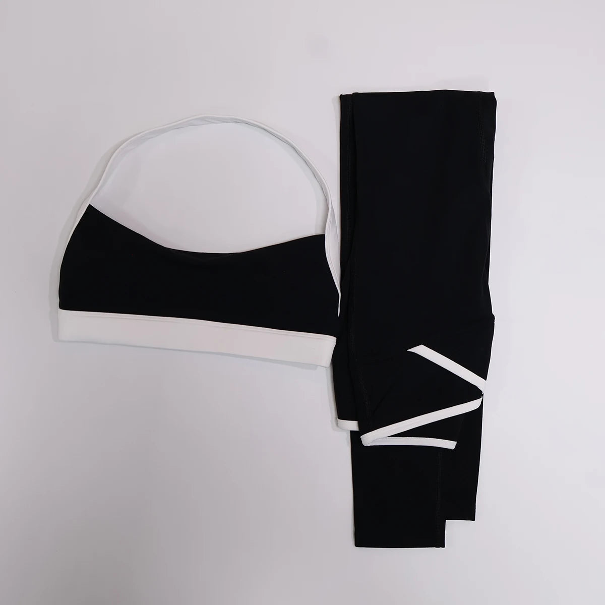 Black butt lift leggings and contrast bra set, flat lay front view