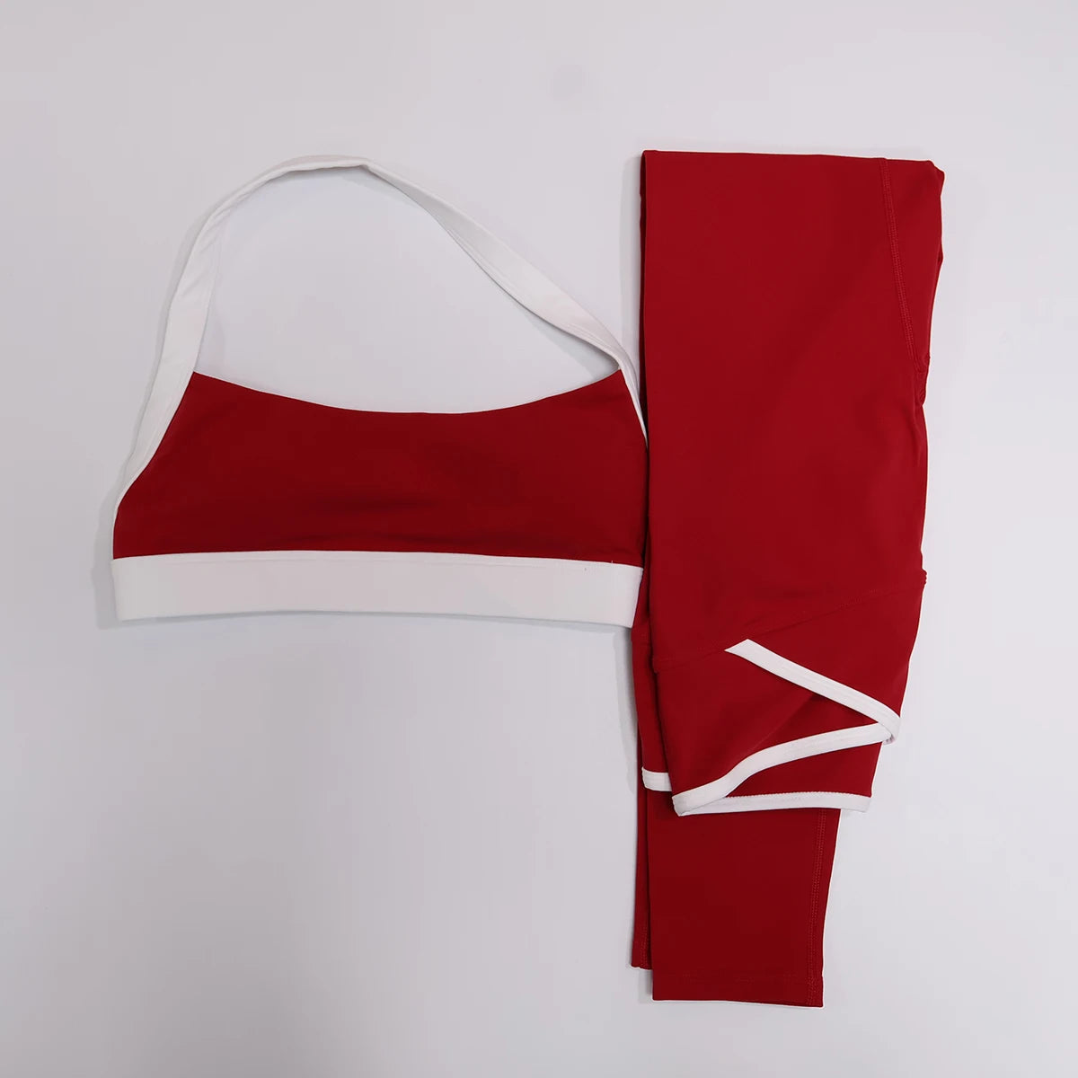 Red leggings and contrast sports bra set, flat lay front view