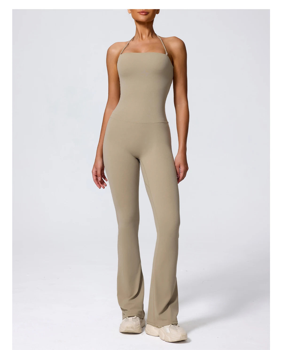 Sand jumpsuit front view, halter neck and flared leg on model