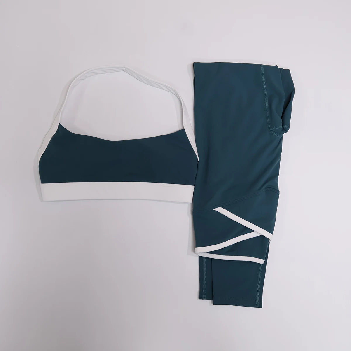 Teal green leggings set with contrast trim, flat lay front view
