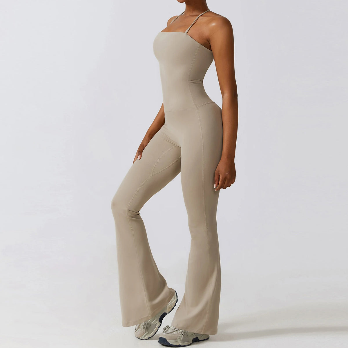 Sand wide leg jumpsuit, side view showing the flare falling from mid-thigh