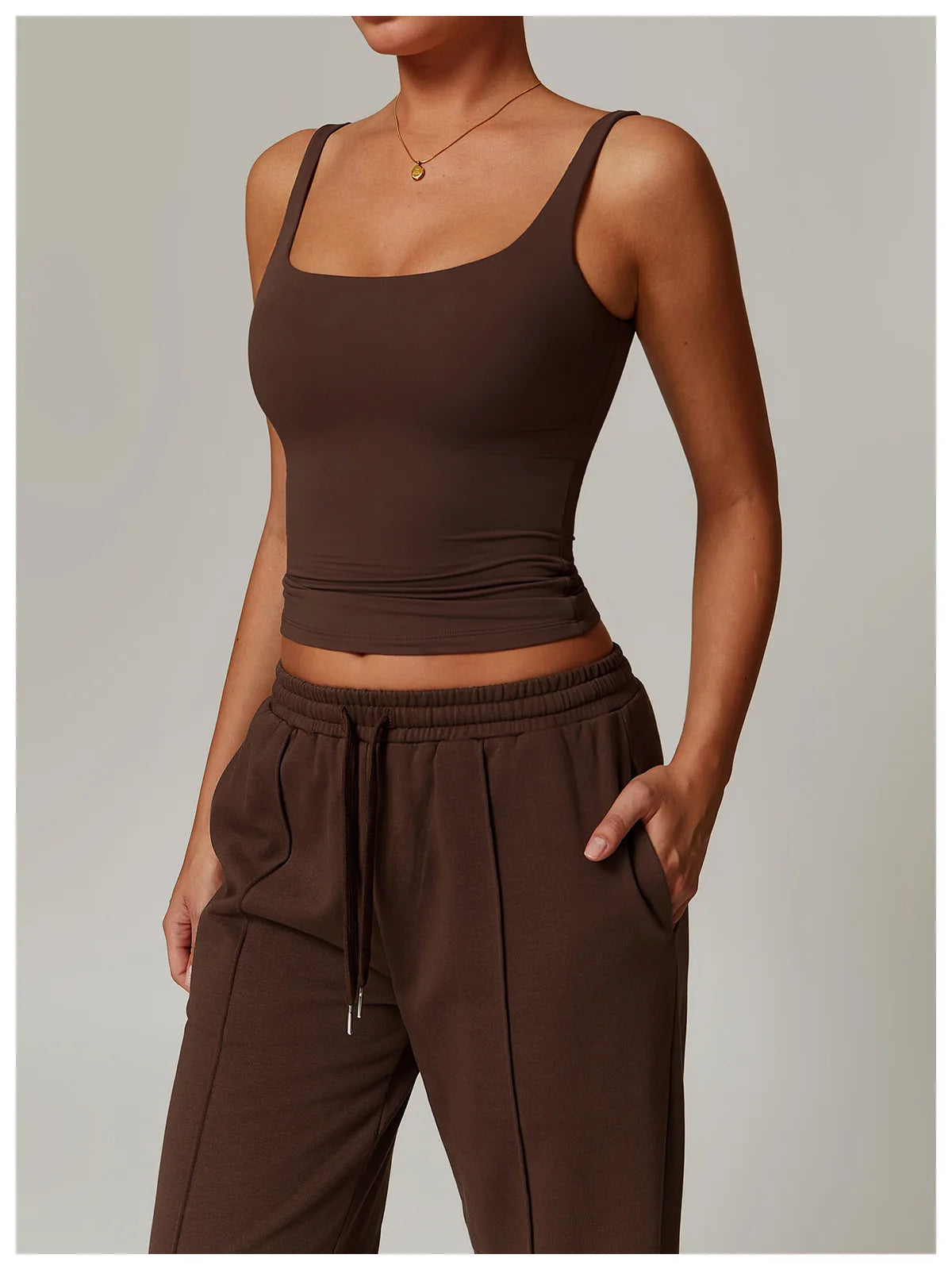 Coffee brown fitted tank top worn with wide leg trousers, front view