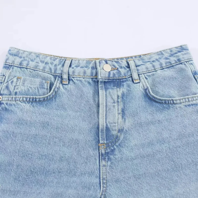 Waistband and zip fly of light wash jeans, flat lay
