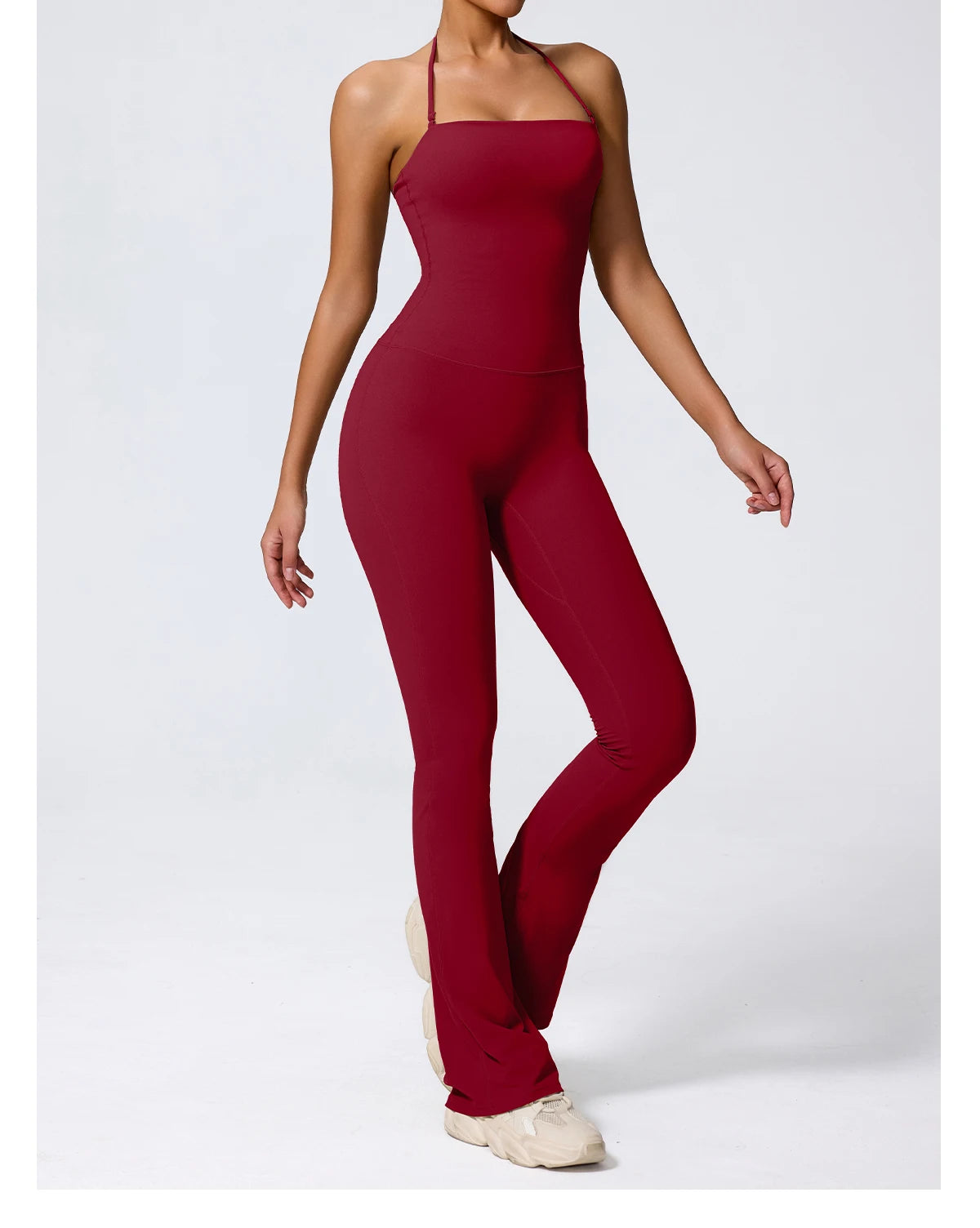 Burgundy jumpsuit three-quarter view showing the unbroken waist seam