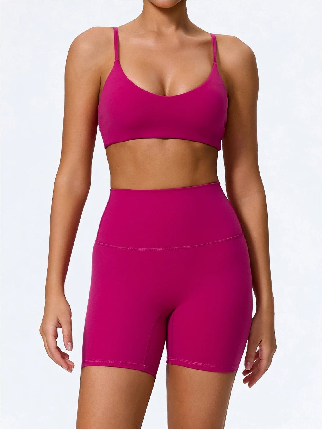Biker shorts and sports bra set in rose red, front view with high waist