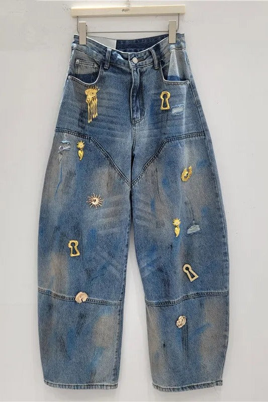 Embellished barrel jeans with gold charms, flat lay hanging, front