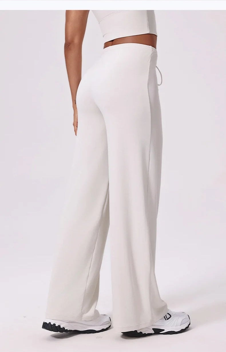 White loose yoga pants side view showing the wide leg drape