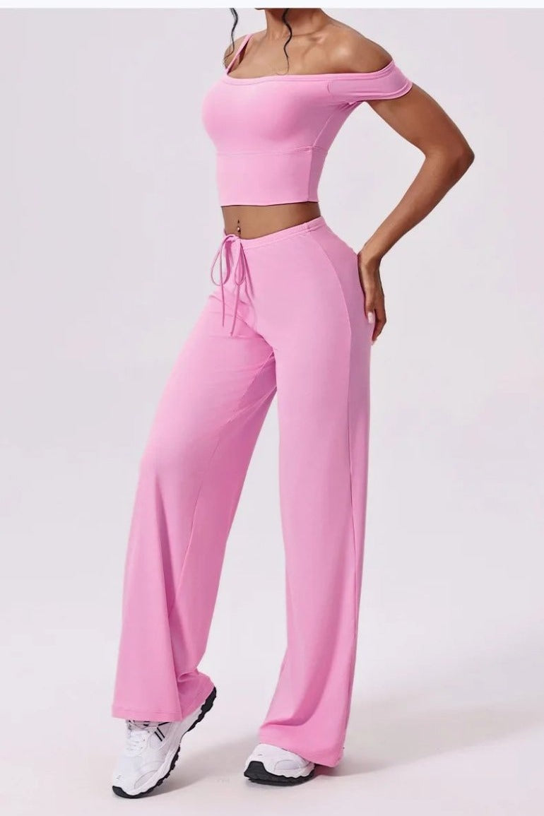 Pink wide leg yoga pants, side view with hand on hip