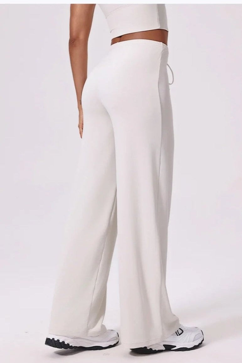 White high waisted yoga pants, back, full length over trainers