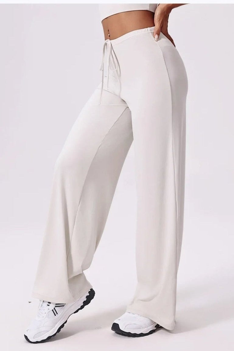 White loose yoga pants, side view, drawstring waist