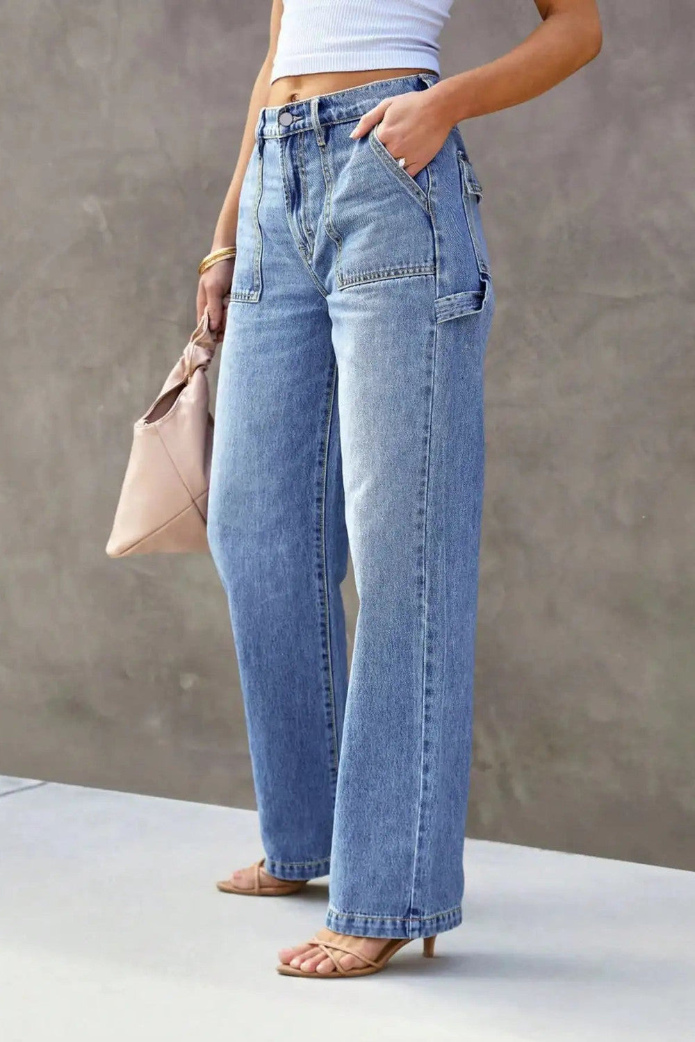 Front pocket detail on light blue wide leg jeans with a high rise waistband