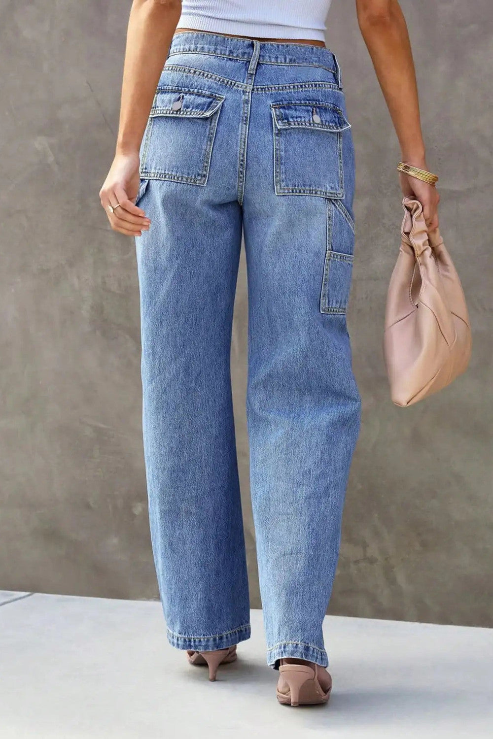 Back view of light blue wide leg jeans showing the flap patch pockets